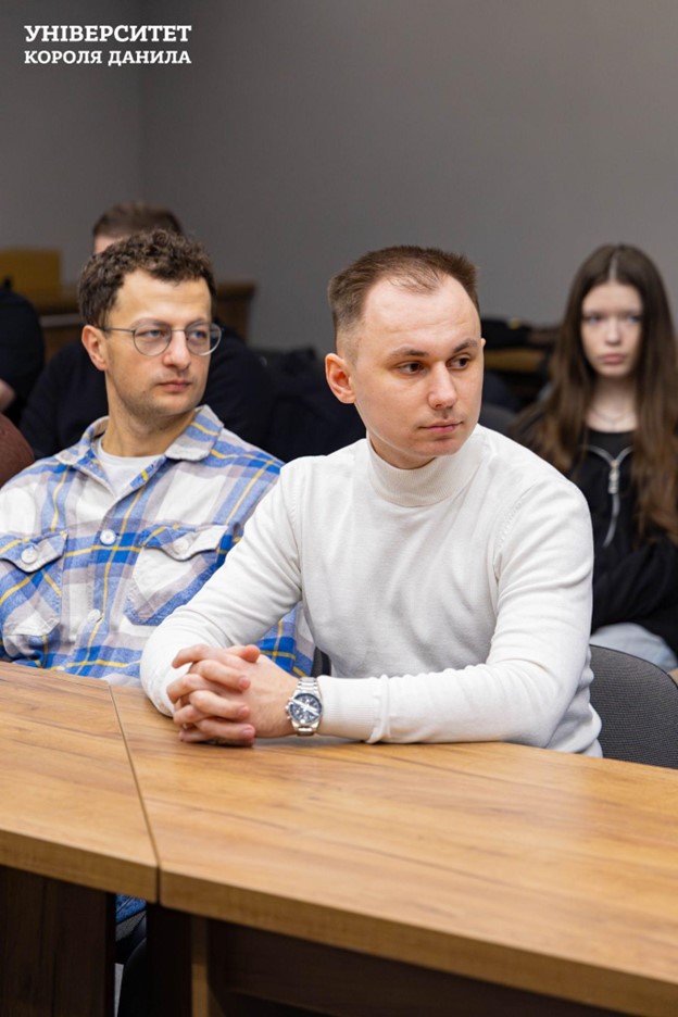 One of the attendees listening to the presenter