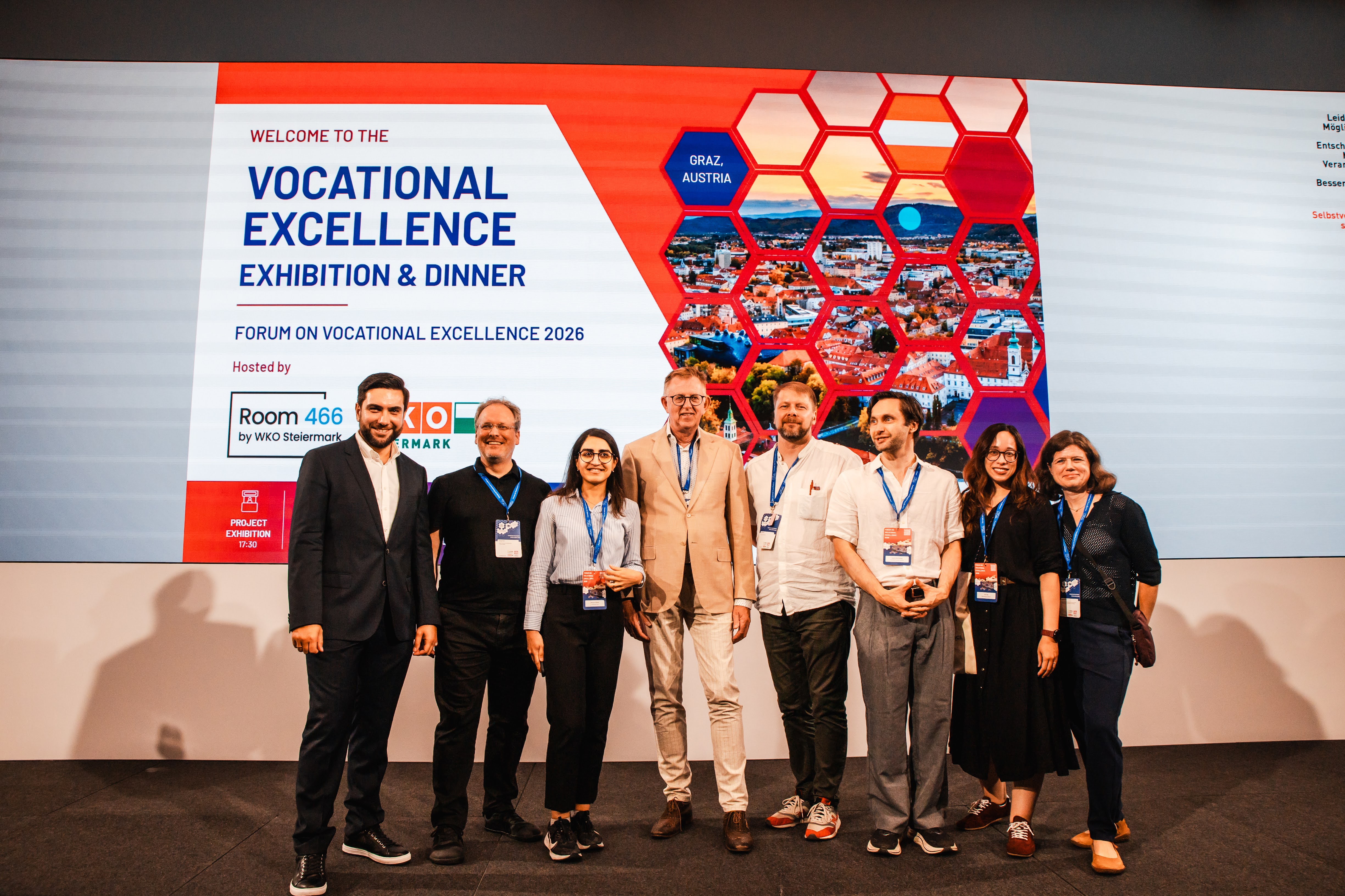A group photo of the H2CoVE Team in front of the Vocational Excellence Exhibition banner