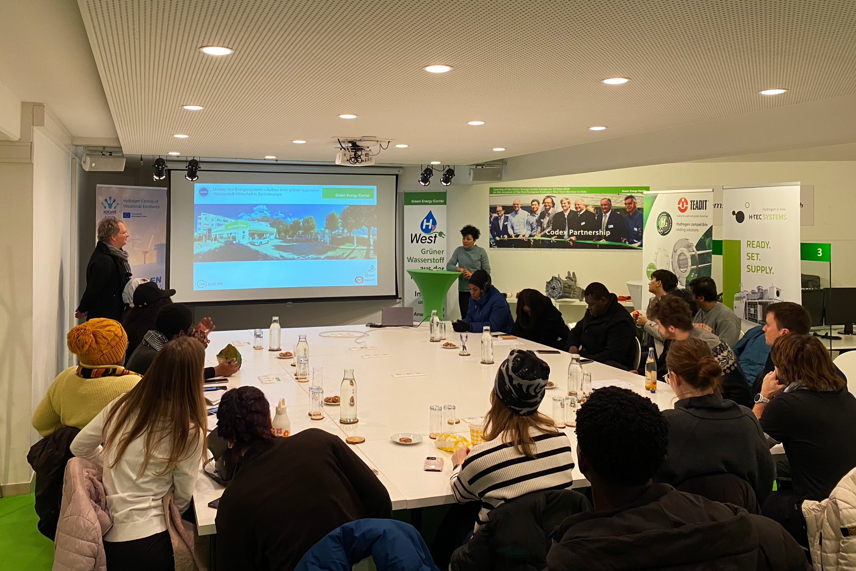 Students seated in a conference room listening to a lecture by Niusha Shakibi-nia and Christian Huber