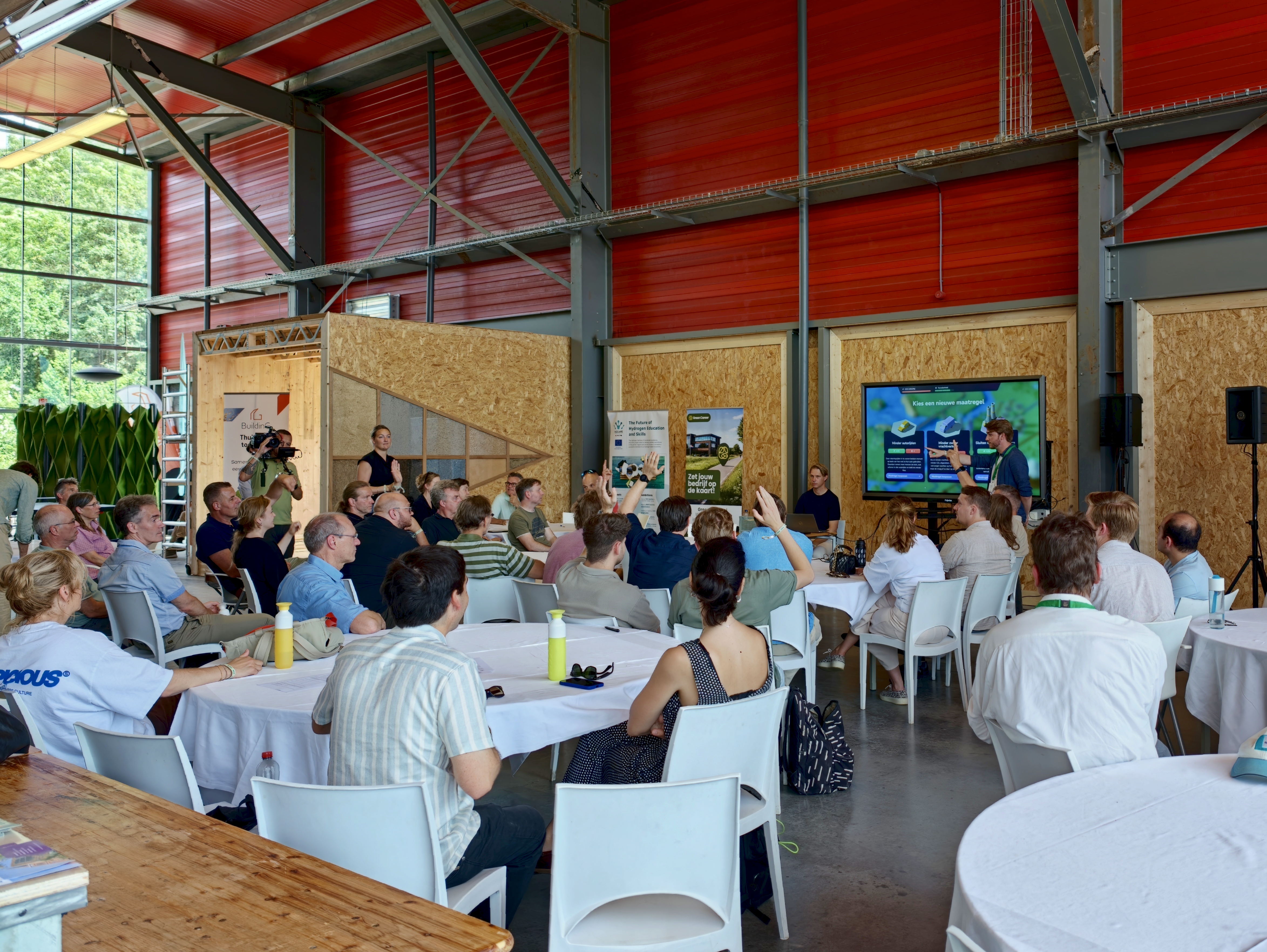 A picture of participants at New Energy Forum listening to a presentation