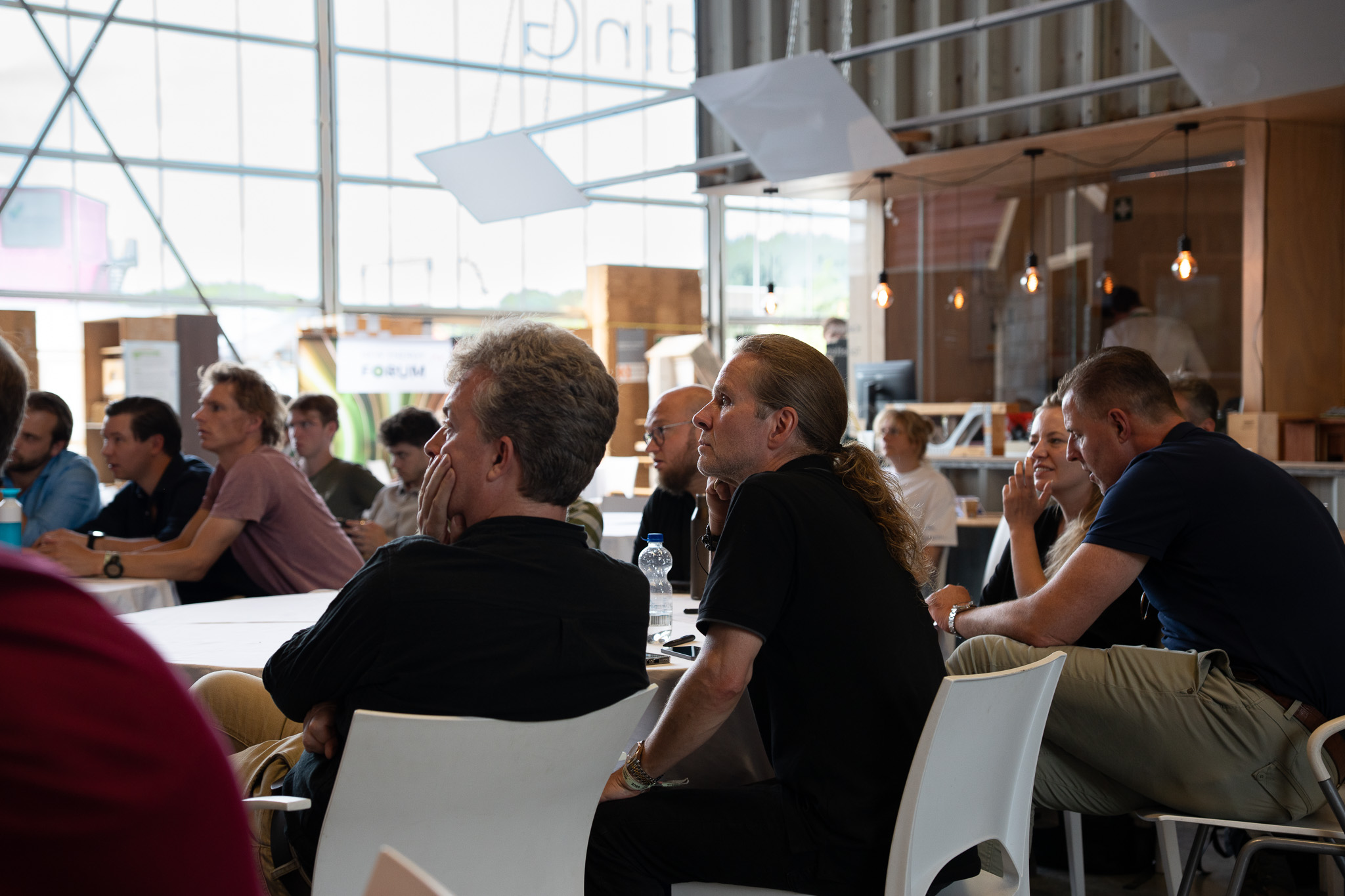 Participants seated at the New Energy Forum, listening during a session.